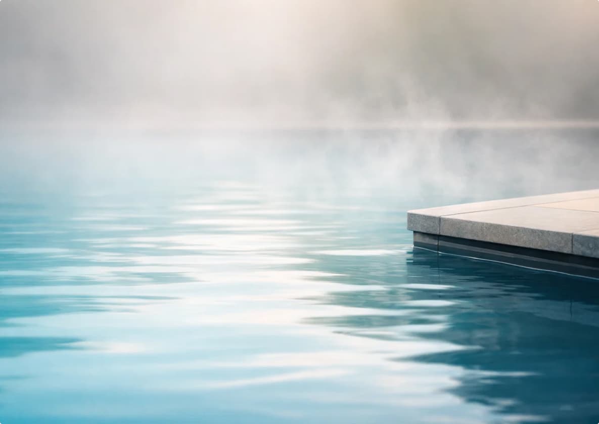 Steam rising from thermal pool water